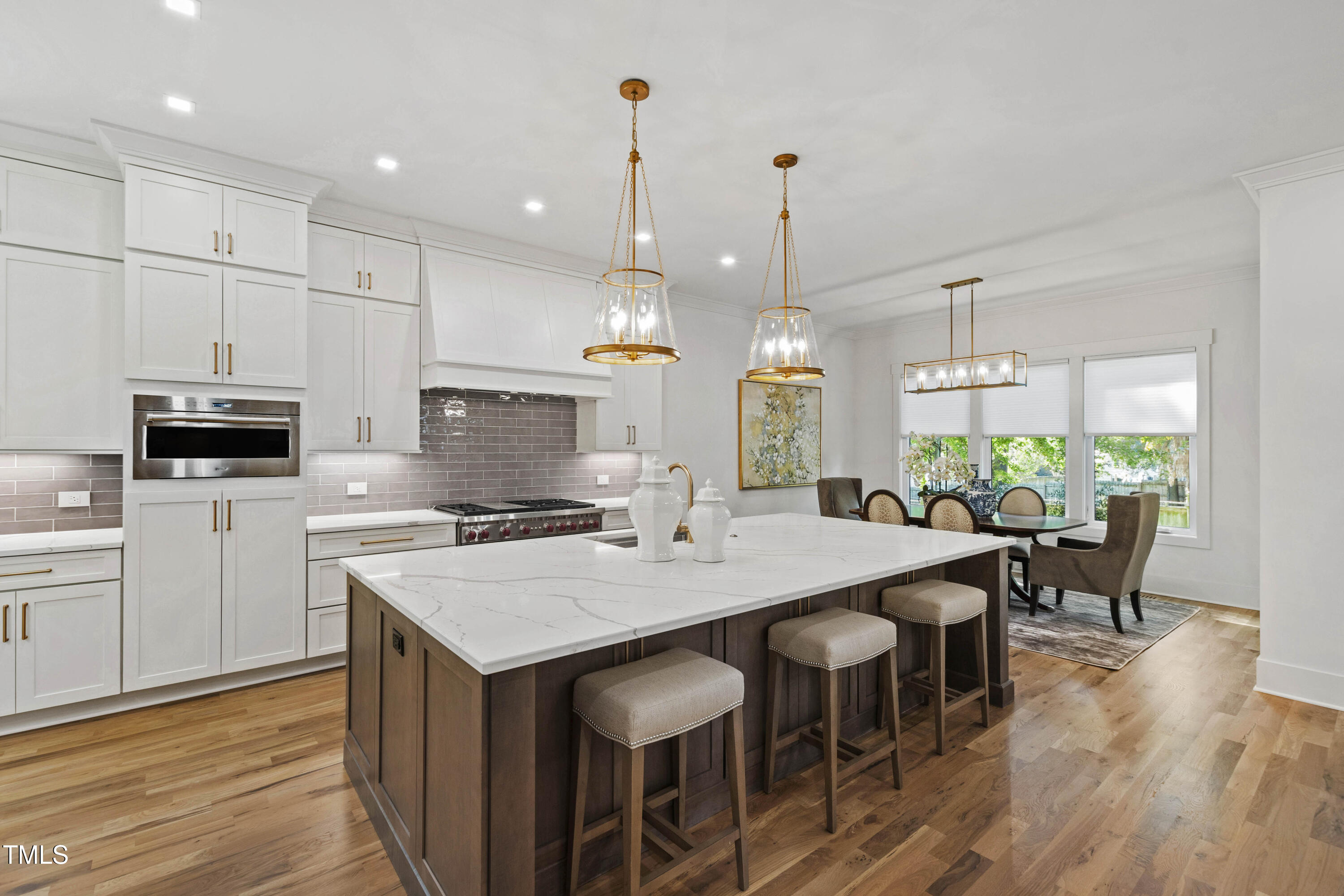 202 Georgetown Road Raleigh, NC 27608 - Photo 16 of 64 a kitchen with appliances a table chairs sink and cabinets