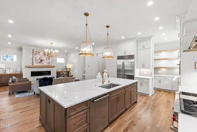 a kitchen with stainless steel appliances a refrigerator and a sink