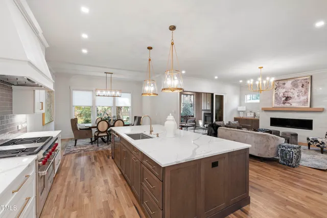 a living room with furniture a fireplace and a table