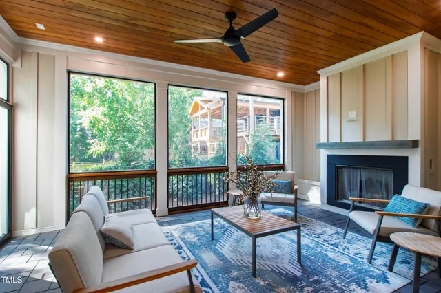 a bedroom with a bed lamp and a large window