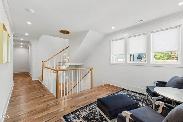 an empty room with windows and cabinet