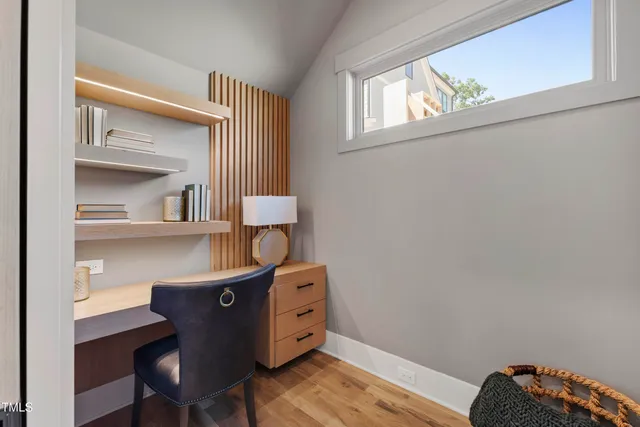 a room with a chair and wooden floor