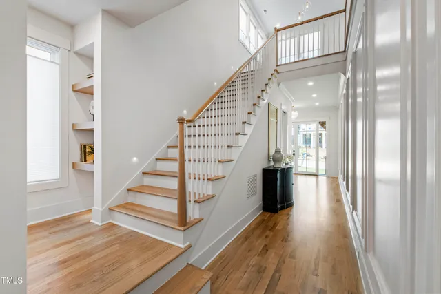 a view of entryway and hall with wooden floor