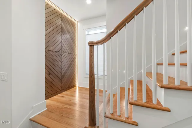 a living room with furniture a fireplace and a large window