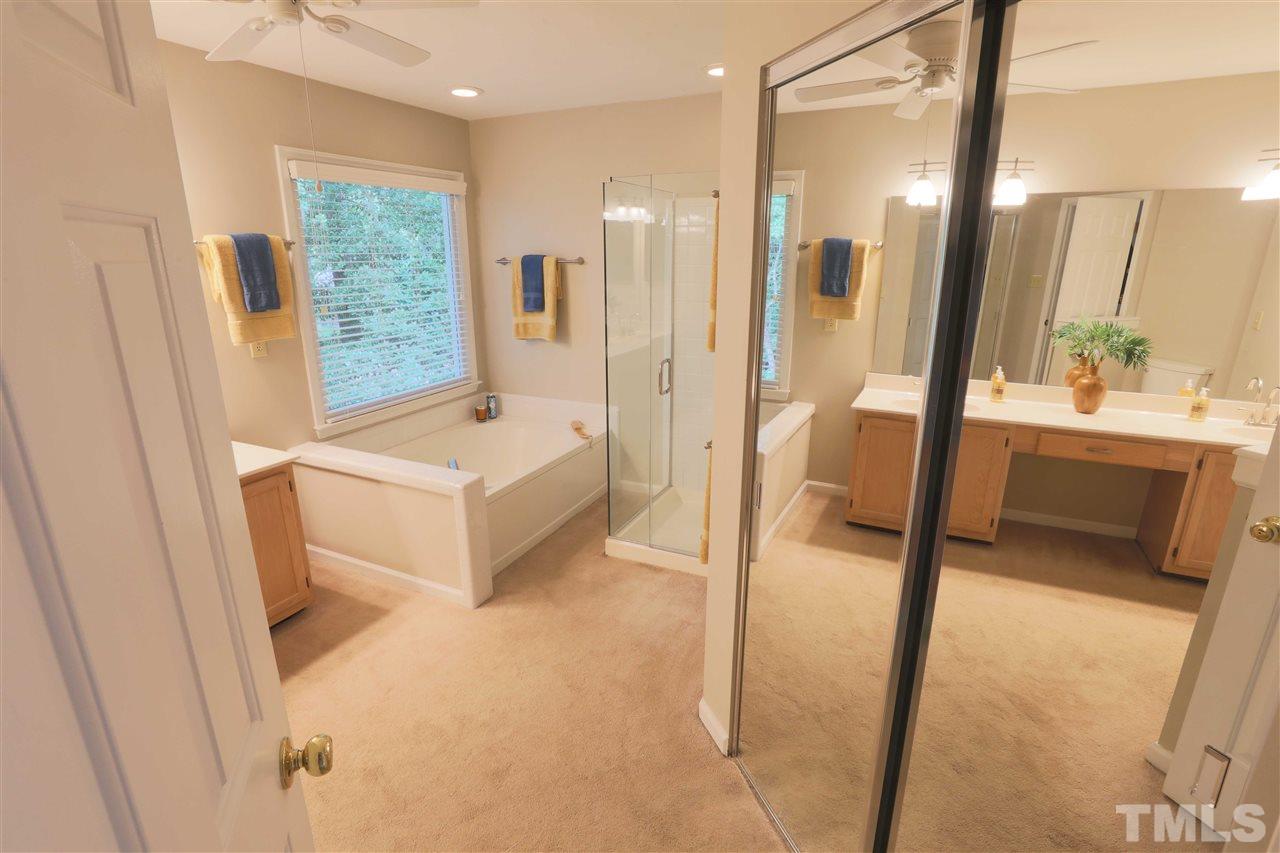 5625 Barham Court Raleigh, NC 27613 - Photo 14 of 23 a spacious bathroom with a tub and shower