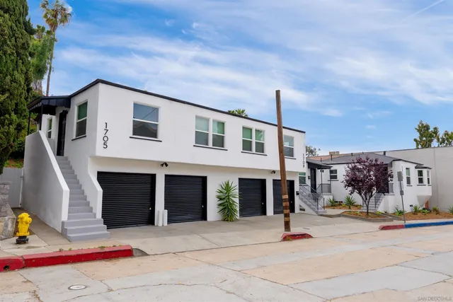 a backyard of a house with garage and outdoor seating