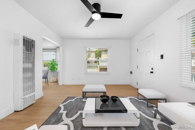 a living room with furniture and a potted plant