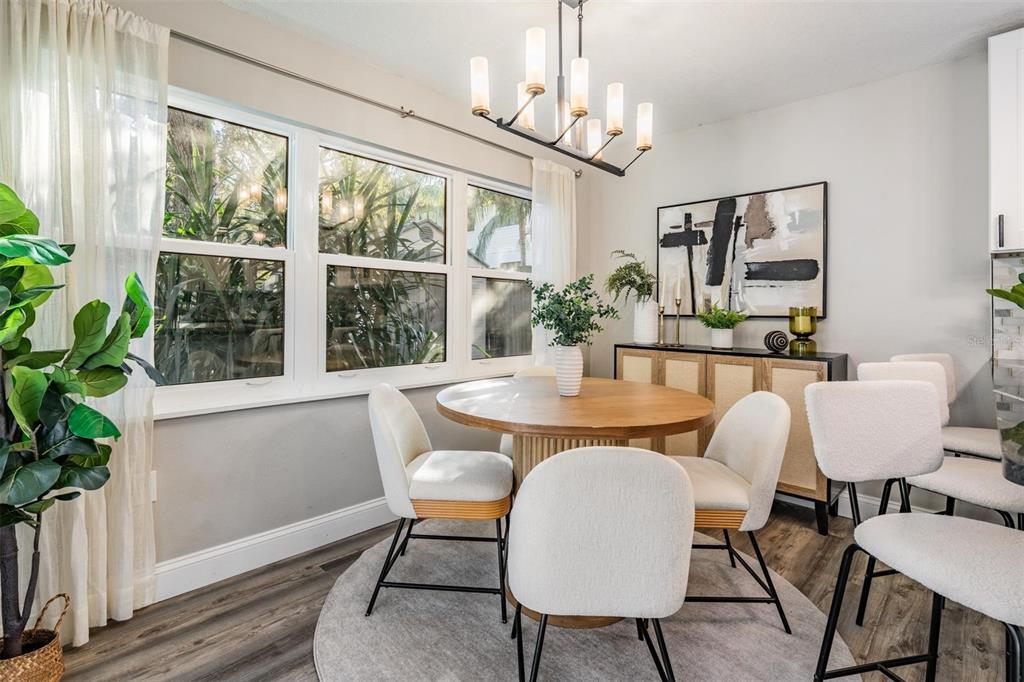 3216 West Fielder Street Tampa, FL 33611 - Photo 11 of 34 a dining room with furniture potted plants and wooden floor