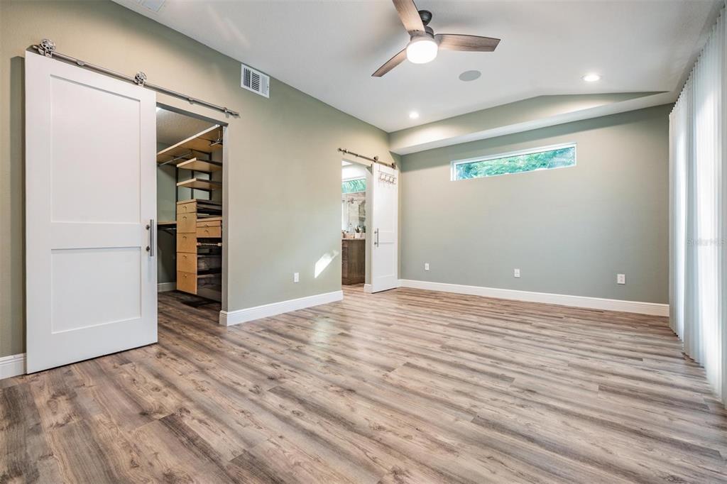 3216 West Fielder Street Tampa, FL 33611 - Photo 13 of 34 an empty room with wooden floor closet and windows