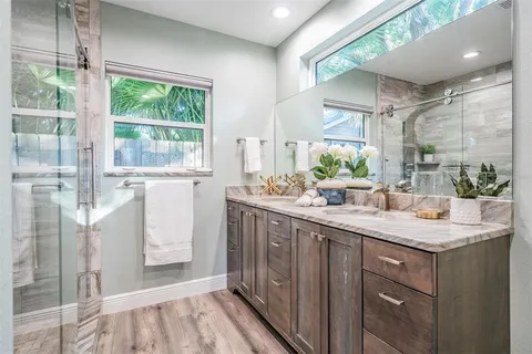 a kitchen with granite countertop a sink and a refrigerator