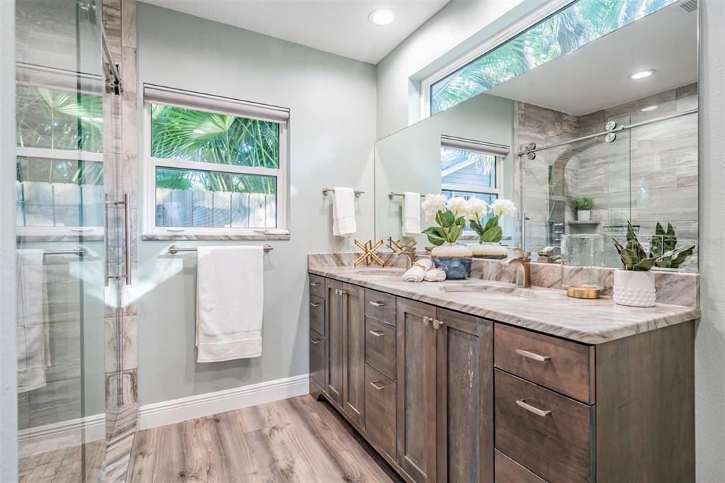 3216 West Fielder Street Tampa, FL 33611 - Photo 14 of 34 a bathroom with a double vanity sink and a mirror