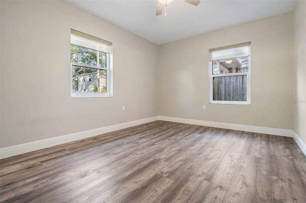 3216 West Fielder Street Tampa, FL 33611 - Photo 18 of 34 a view of an empty room with wooden floor and a window