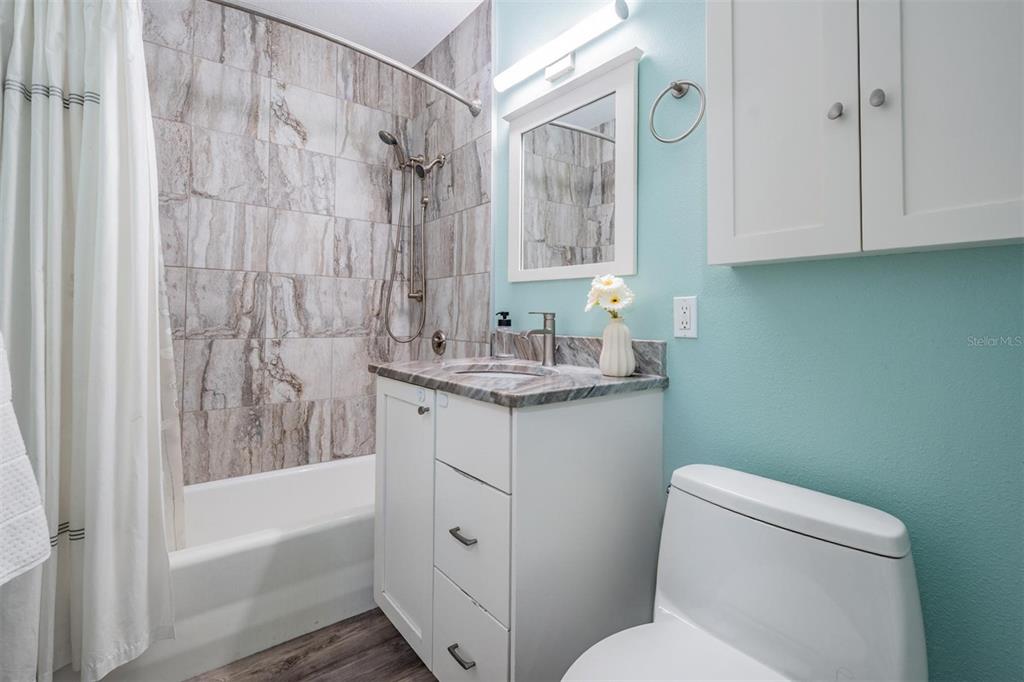 3216 West Fielder Street Tampa, FL 33611 - Photo 20 of 34 a bathroom with a granite countertop sink toilet and shower