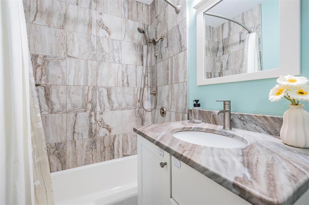3216 West Fielder Street Tampa, FL 33611 - Photo 21 of 34 a bathroom with a granite countertop sink and a mirror