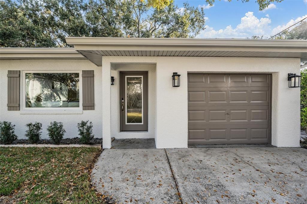 3216 West Fielder Street Tampa, FL 33611 - Photo 30 of 34 a front view of a house with a yard