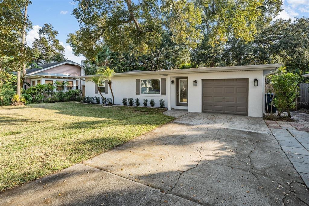 3216 West Fielder Street Tampa, FL 33611 - Photo 32 of 34 a view of a house with a yard and large tree