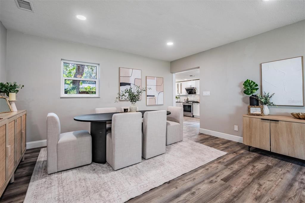 3216 West Fielder Street Tampa, FL 33611 - Photo 4 of 34 a living room with furniture a dining table and wooden floor