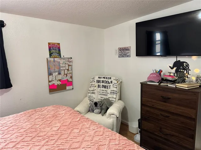 a bedroom with a bed and dresser