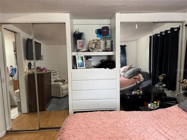 a room with a bed and a television