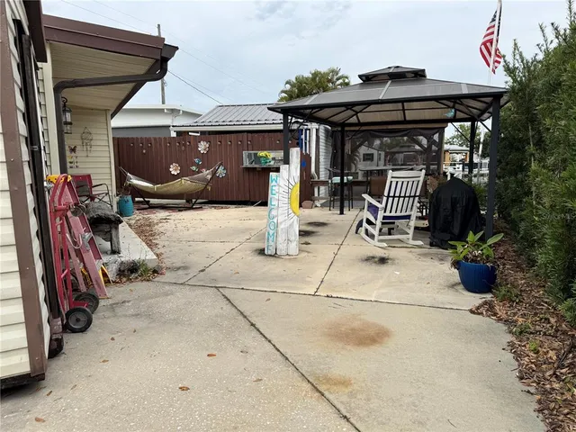 a view of a patio with table and chairs under an umbrella