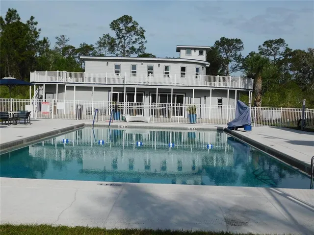 a view of swimming pool with outdoor seating