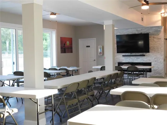 a living room with stainless steel appliances kitchen island granite countertop a sink and a microwave