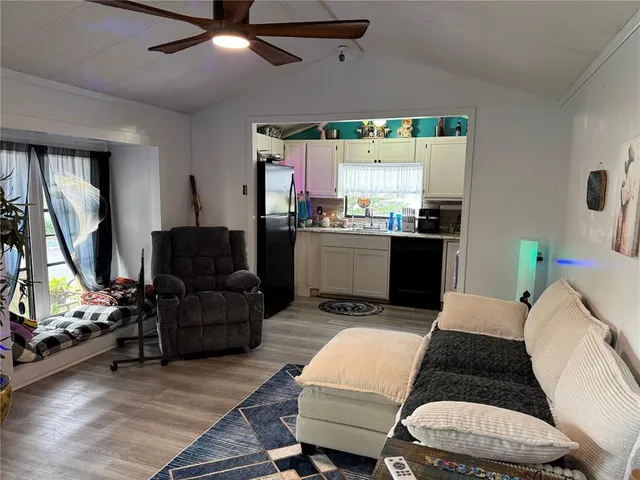 a room with furniture a flat screen tv and a large window