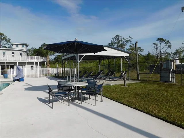a view of backyard with outdoor seating and plants