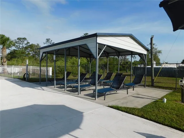 a view of a backyard with sitting area