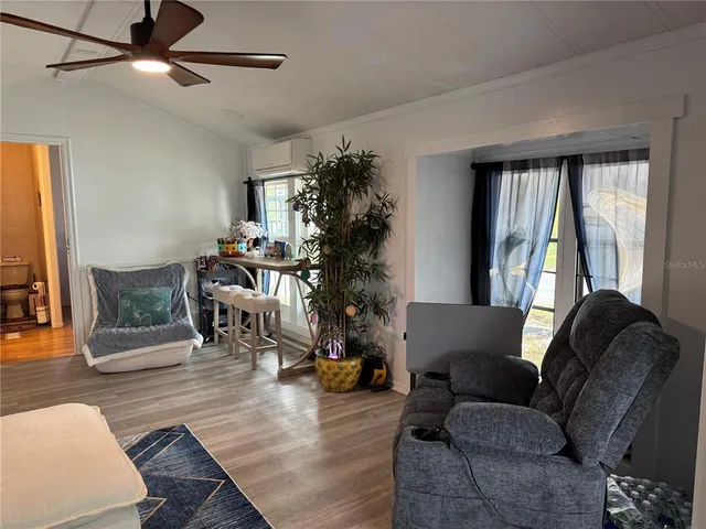 a living room with furniture and wooden floor