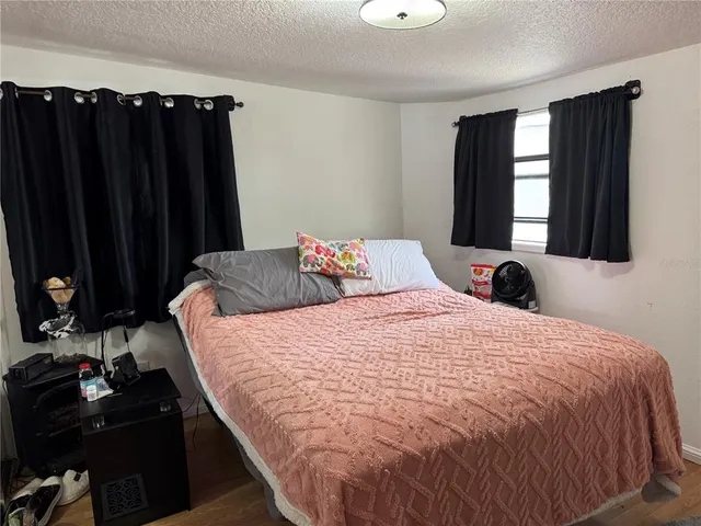 a bedroom with a bed and window