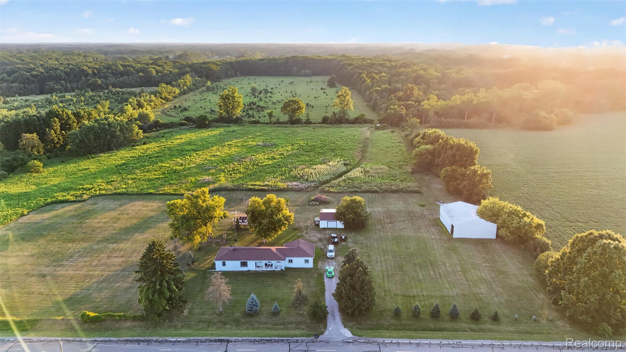 7369 North Webster Road Mount Morris, MI 48458 - Photo 51 of 56 Expansive property with a single-story residence, detached garage, and a large white barn