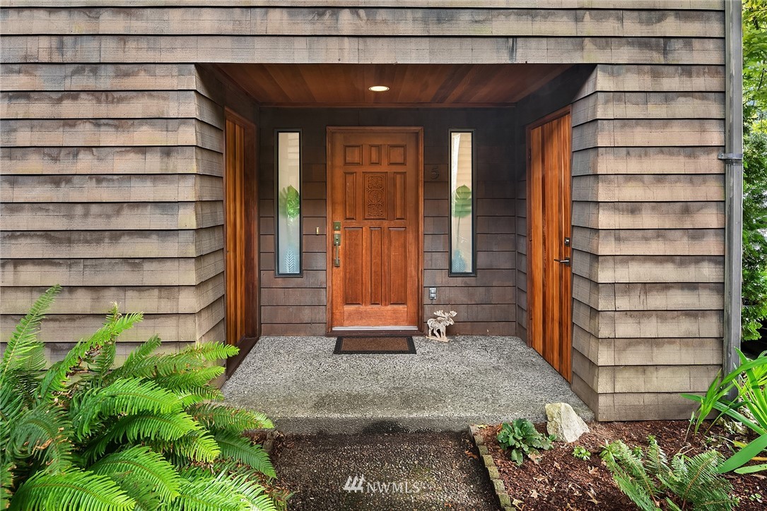 7512 218th Street Southwest, Unit 5 Edmonds, WA 98026 - Photo 1 of 25 a front view of a house with a yard