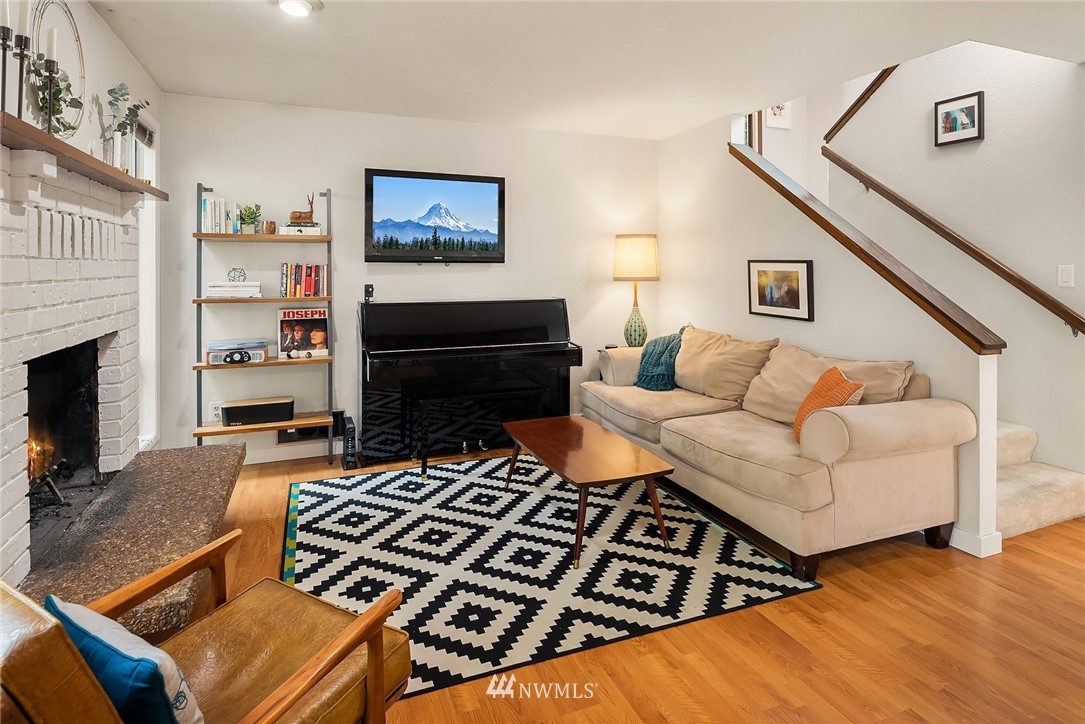 7512 218th Street Southwest, Unit 5 Edmonds, WA 98026 - Photo 11 of 25 a living room with furniture and a fireplace