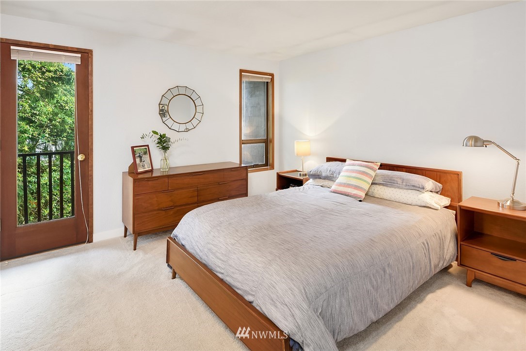 7512 218th Street Southwest, Unit 5 Edmonds, WA 98026 - Photo 19 of 25 a bedroom with a bed a mirror and a window