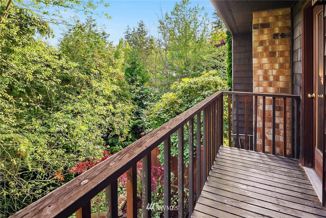 7512 218th Street Southwest, Unit 5 Edmonds, WA 98026 - Photo 21 of 25 a balcony with trees in front of it