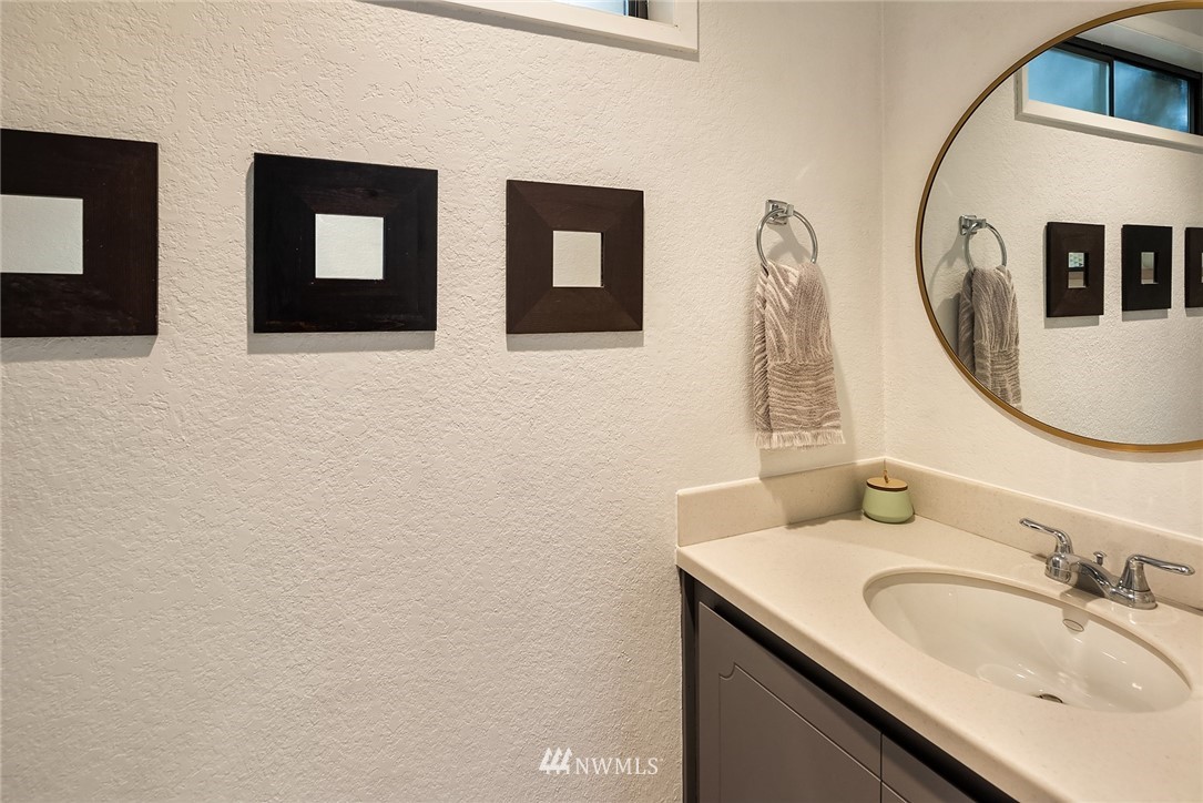 7512 218th Street Southwest, Unit 5 Edmonds, WA 98026 - Photo 23 of 25 a bathroom with a granite countertop sink and a mirror