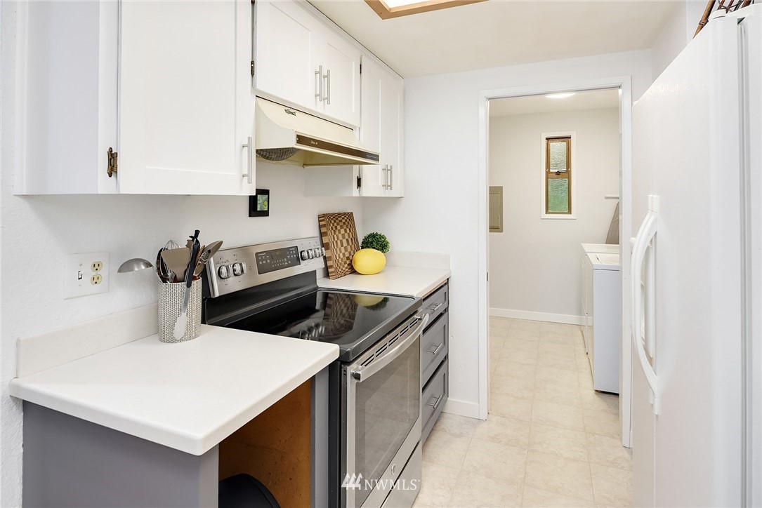 7512 218th Street Southwest, Unit 5 Edmonds, WA 98026 - Photo 7 of 25 a kitchen with a sink a stove and cabinets