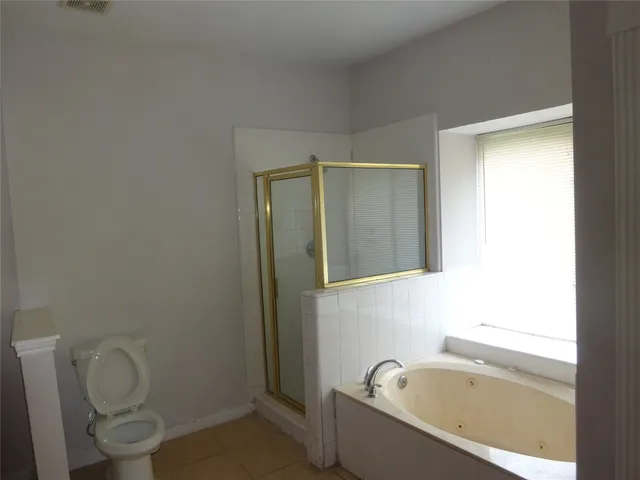 a bathroom with a toilet and a bathtub