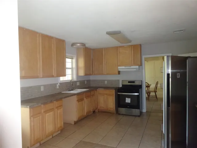 a kitchen with stainless steel appliances granite countertop a sink and cabinets