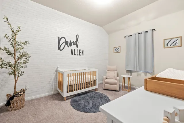 a bedroom with two beds and a chair