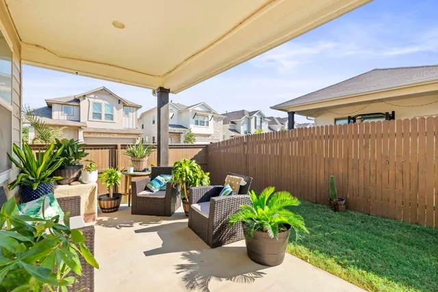 a view of a chairs and table in a backyard