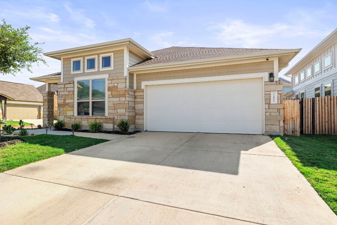 11901 Dispatch Way Austin, TX 78748 - Photo 2 of 18 a front view of a house with a yard and garage