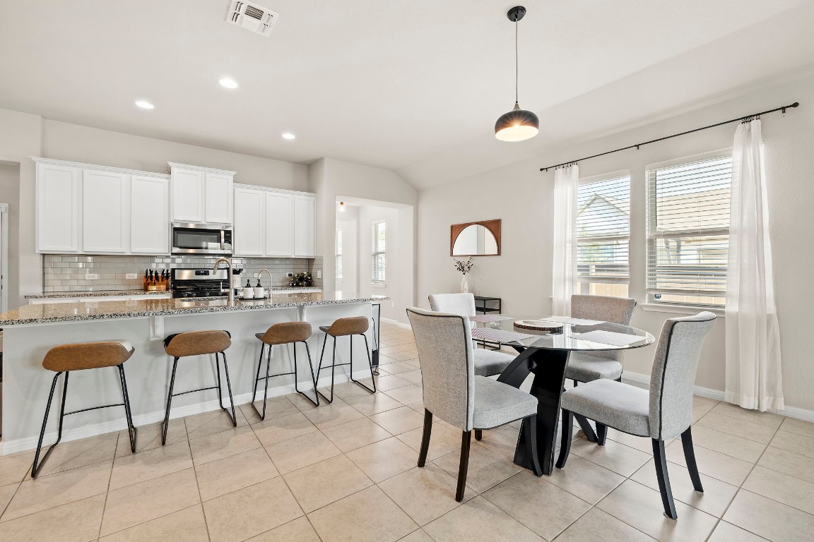 11901 Dispatch Way Austin, TX 78748 - Photo 3 of 18 a kitchen with stainless steel appliances granite countertop a table and chairs