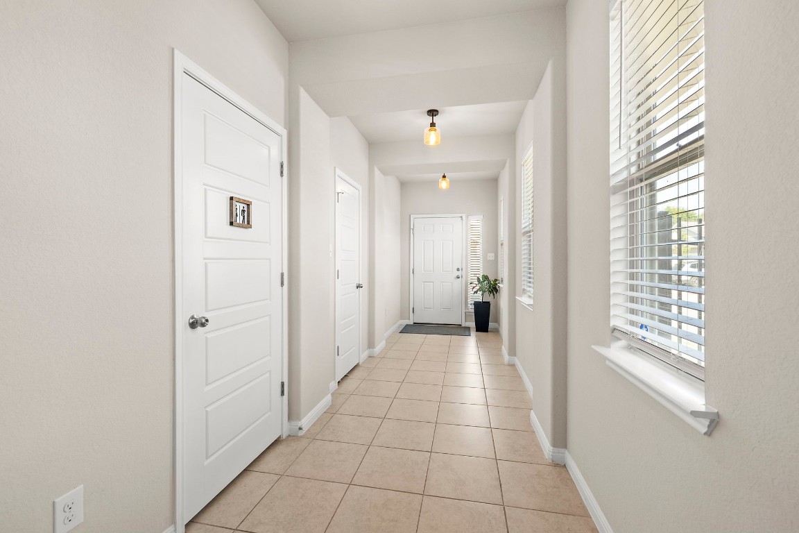 11901 Dispatch Way Austin, TX 78748 - Photo 3 of 18 a view of a hallway with a window and a bathroom