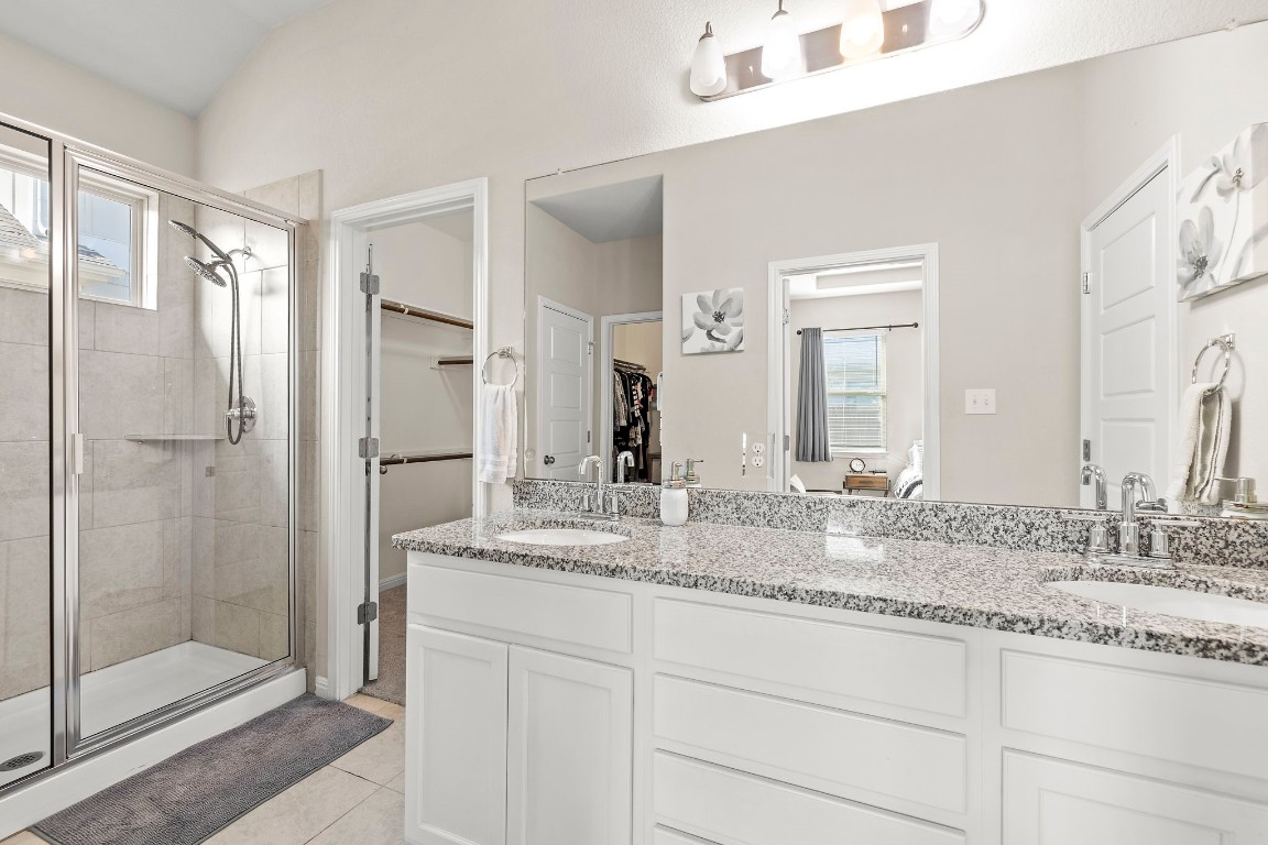 11901 Dispatch Way Austin, TX 78748 - Photo 8 of 18 a bathroom with a granite countertop sink two mirror and shower