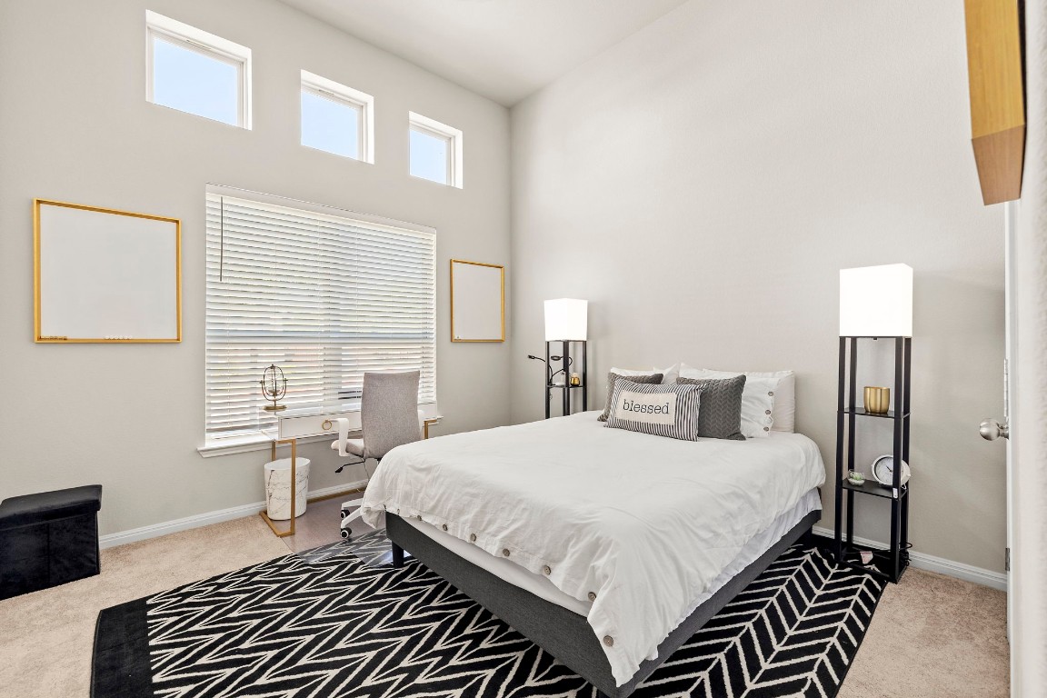 11901 Dispatch Way Austin, TX 78748 - Photo 8 of 18 a bedroom with a bed and a dresser with wooden floor