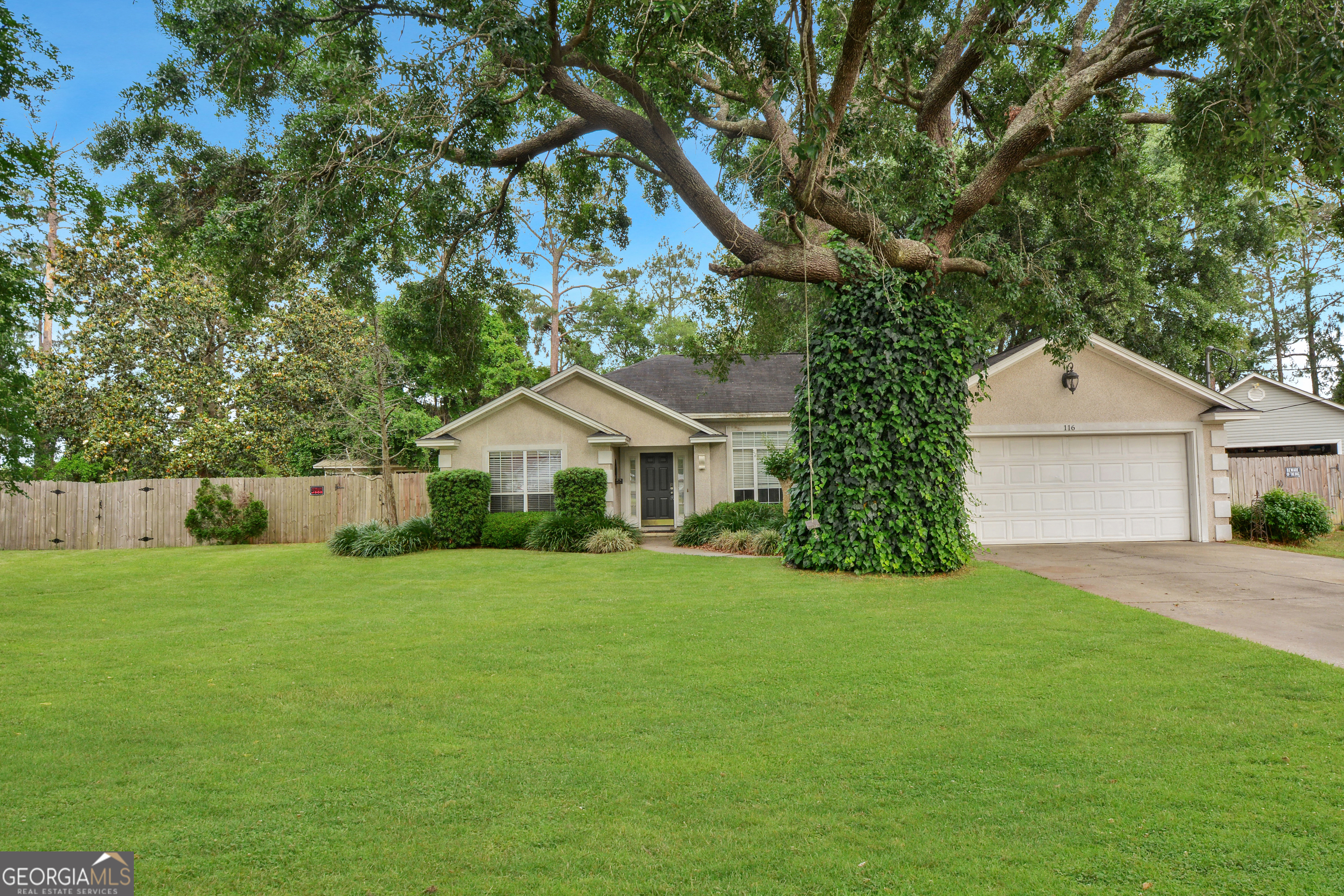 116 Timber Ridge Drive Brunswick, GA 31525 - Photo 1 of 1 a front view of a house with yard and green space