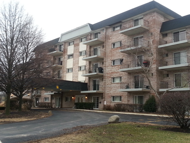 1000 South Lorraine Road, Unit 410 Wheaton, IL 60189 - Photo 1 of 12 a front view of a building with lot of windows