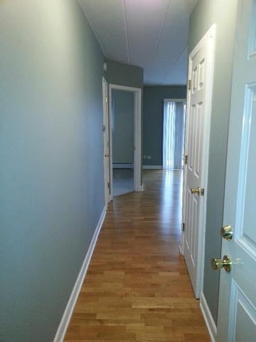1000 South Lorraine Road, Unit 410 Wheaton, IL 60189 - Photo 2 of 12 a view of a hallway with wooden floor